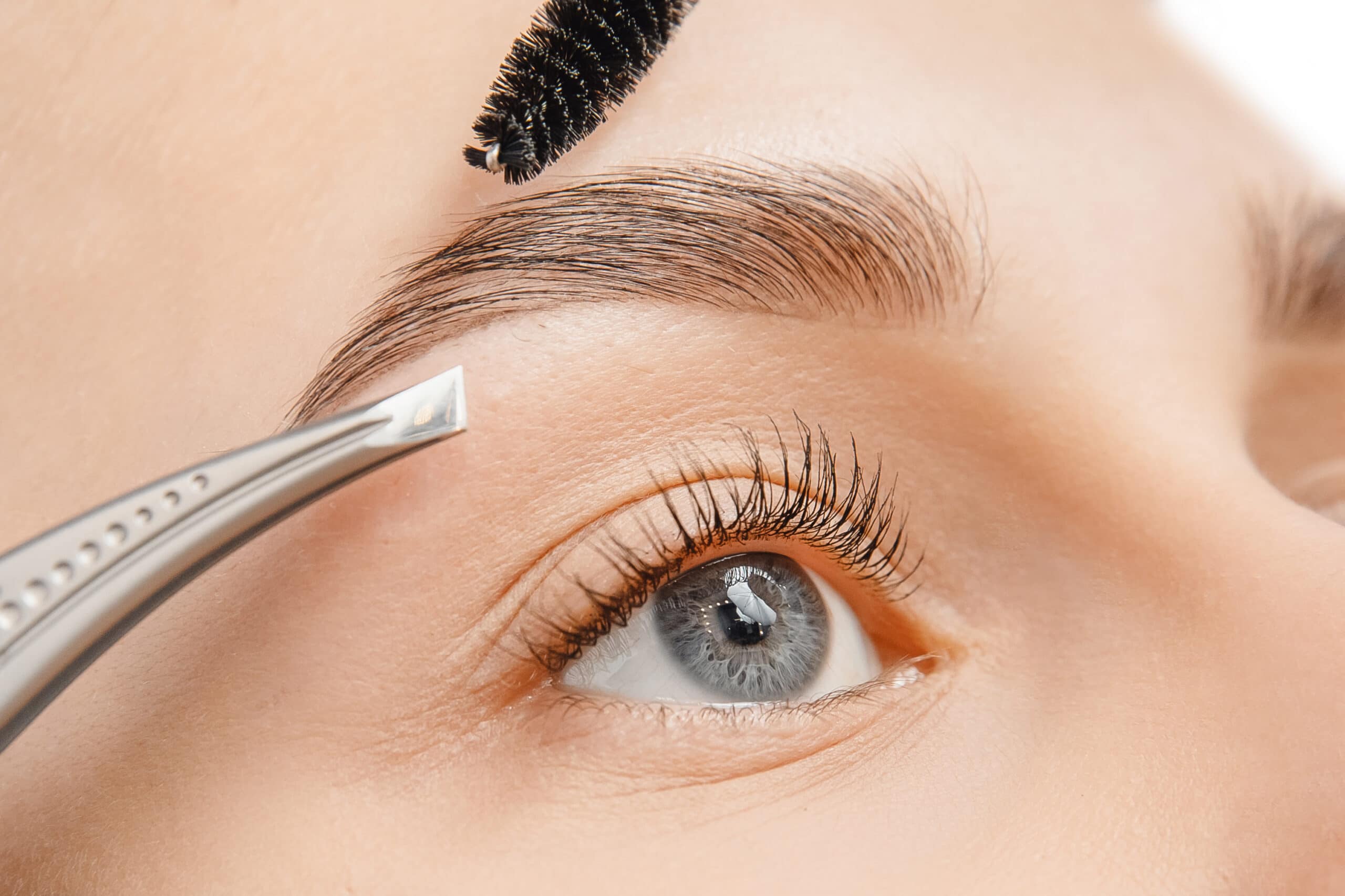 Master tweezers depilation of eyebrow hair in women, brow correction